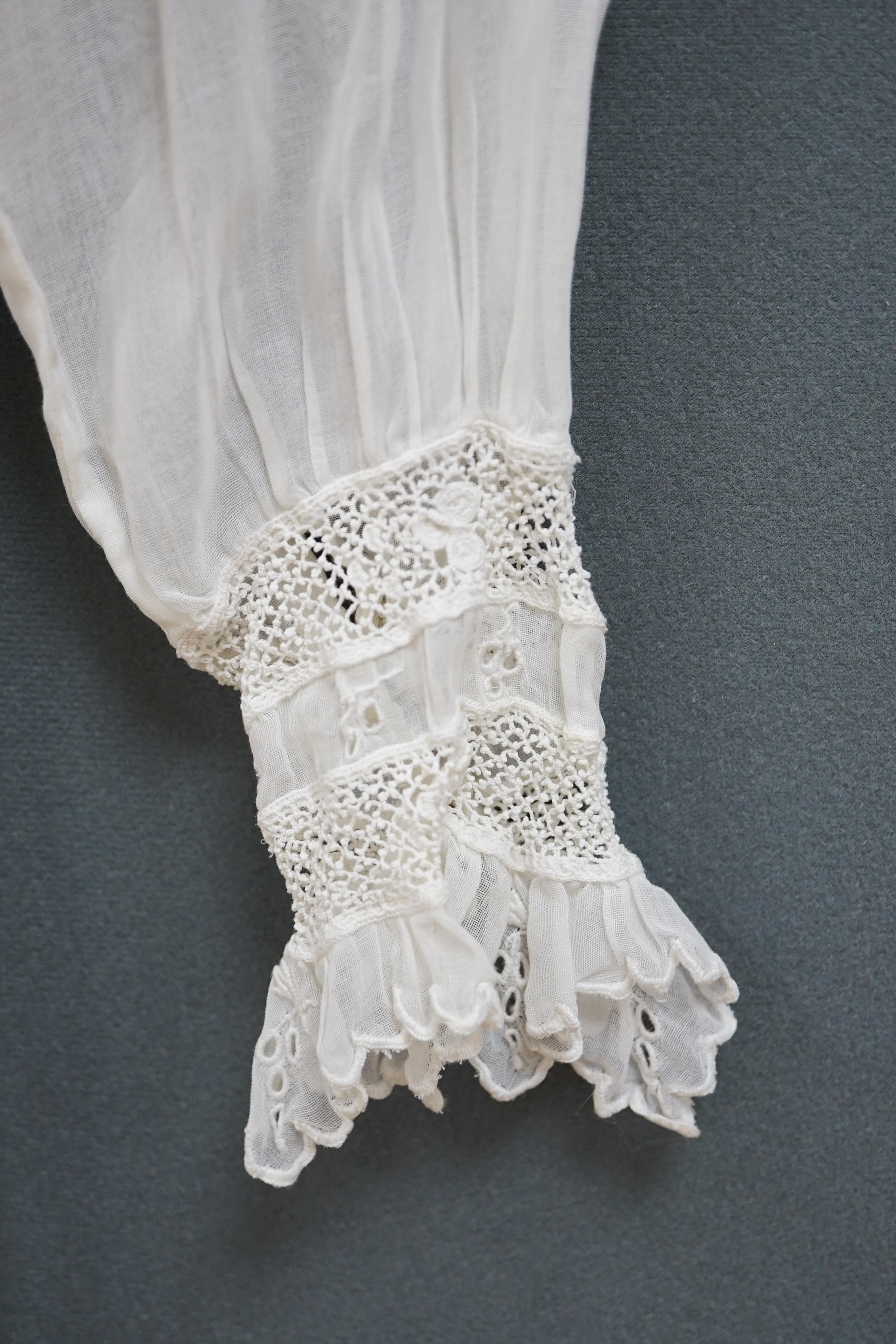 An early Edwardian fine lawn ladies hand made and embroidered crochet dress, embroidered with a white worked skirt, cuffs and lower waist and Irish crochet bodice insertions, with novelty detailing of a faux jacket front